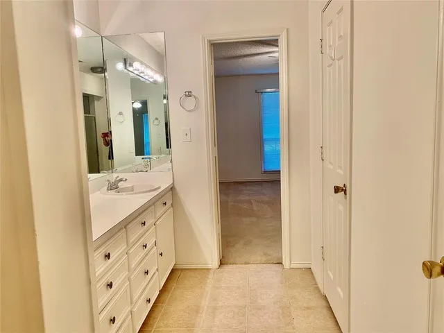 a bathroom with a double vanity sink and mirror
