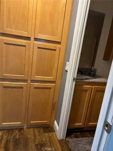 a view of a garden with a bench and potted plants