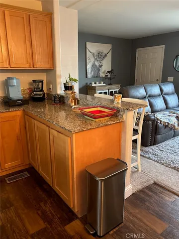 a kitchen with a table chairs and refrigerator