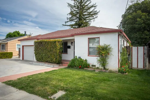 a front view of a house with a garden