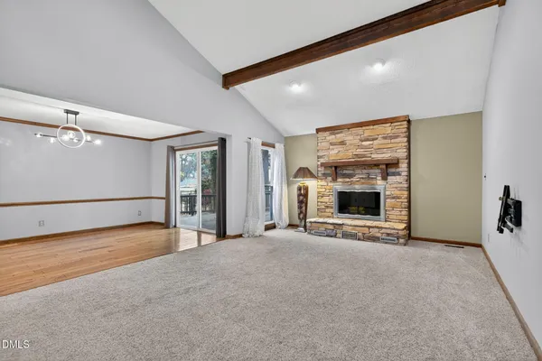 an empty room with a ceiling fan and a window
