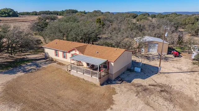 an aerial view of a house with a yard
