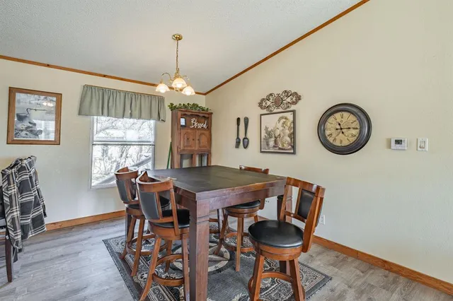 a kitchen with stainless steel appliances kitchen island granite countertop a stove a sink dishwasher and a refrigerator with wooden cabinets