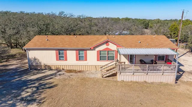 an aerial view of a house with a yard