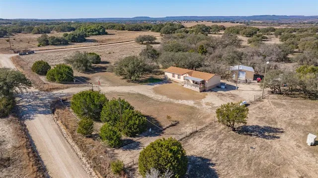 an aerial view of a house with a yard