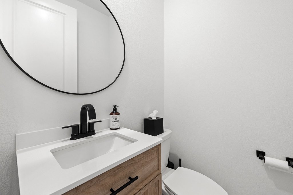 365 Pear Tree Lane Austin, TX 78737 - Photo 37 of 39 a bathroom with a toilet sink and mirror