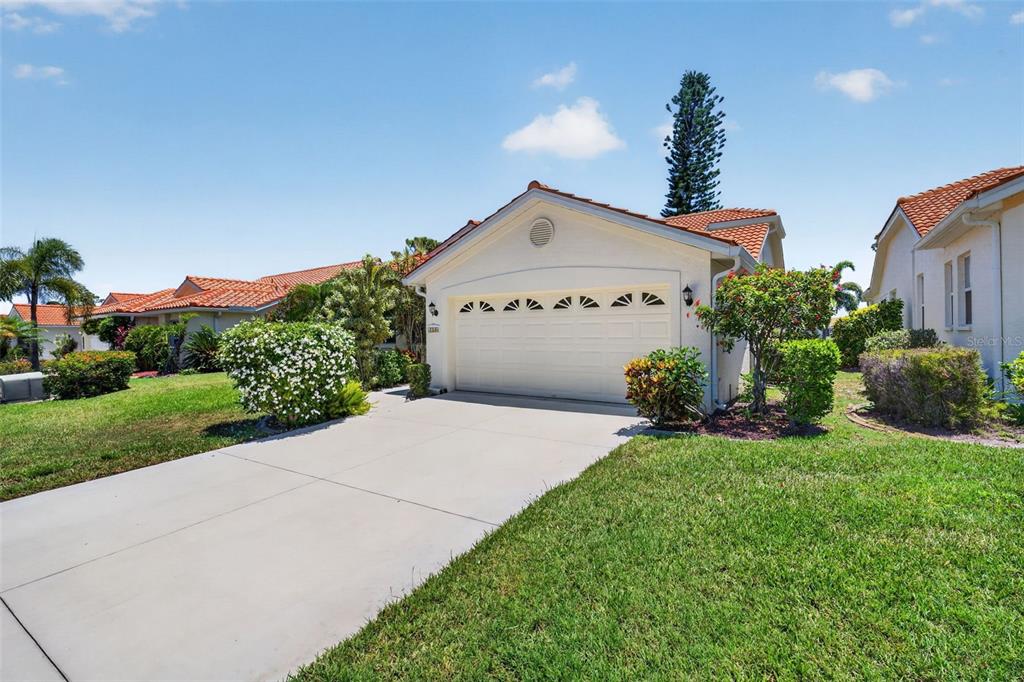 4266 Summertree Road Venice, FL 34293 - Photo 41 of 64 a front view of a house with a yard and garage