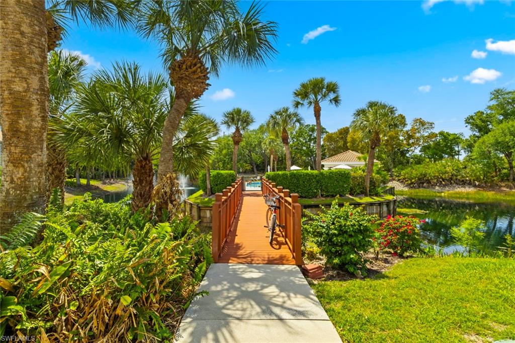 6812 Satinleaf Road South, Unit 202 Naples, FL 34109 - Photo 39 of 49 View of property's community with a swimming pool, a wooden deck lounge area
