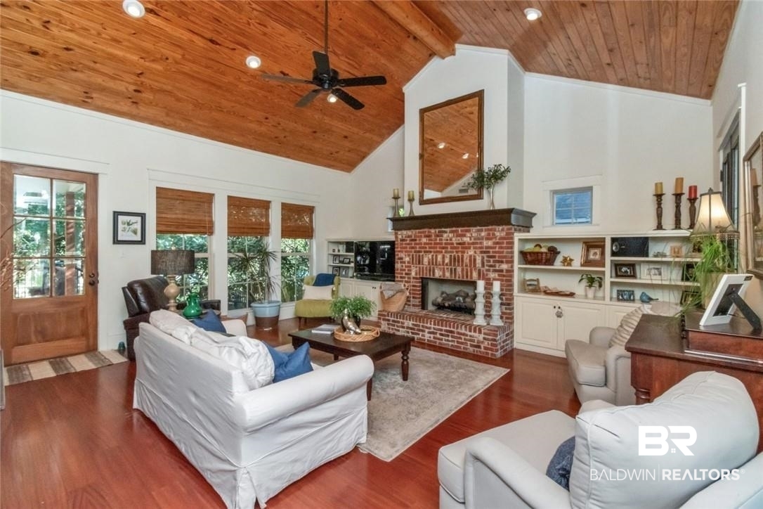 8868 Dawes Lake Road South Mobile, AL 36619 - Photo 3 of 35 Living room featuring wood ceiling, dark hardwood / wood-style floors, a fireplace, high vaulted ceiling, and ceiling fan