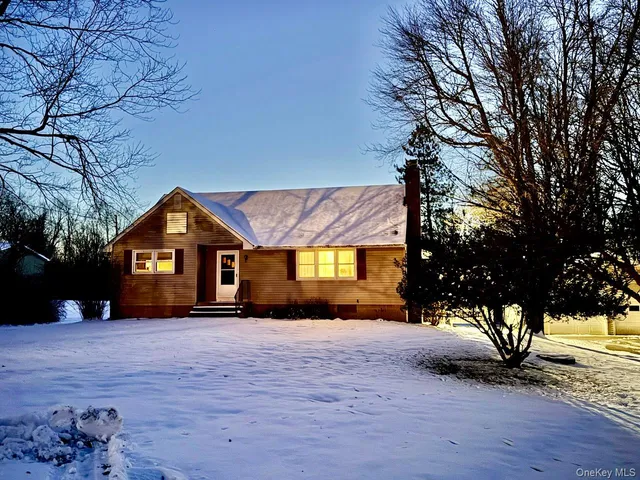 a view of a house with a yard covered in snow