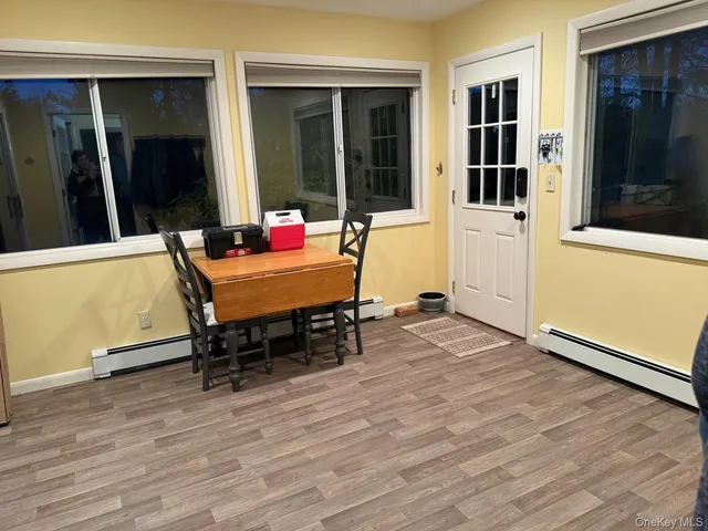 an outdoor sitting area with furniture and wooden floors