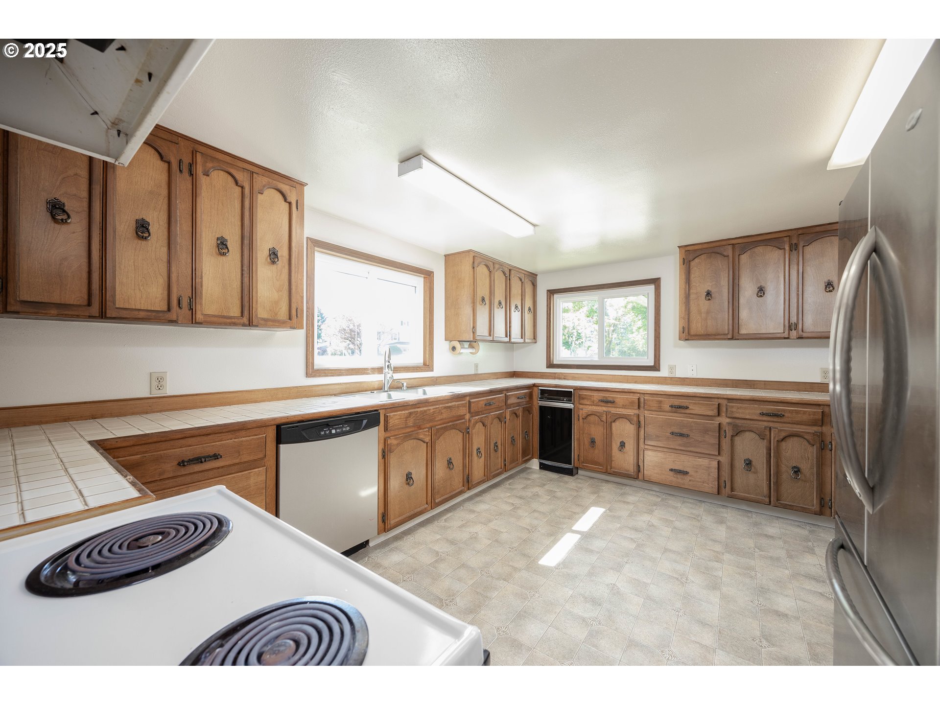 710 North Main Avenue Ridgefield, WA 98642 - Photo 8 of 30 a kitchen with stainless steel appliances kitchen island granite countertop a sink and cabinets