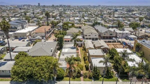 an aerial view of residential houses with outdoor space