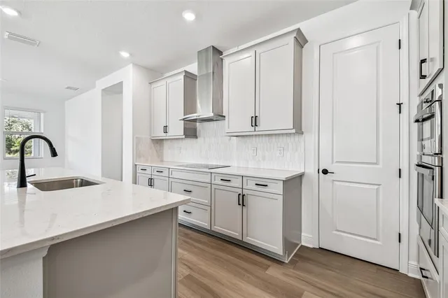 a view of a kitchen with wooden floor and a refrigerator