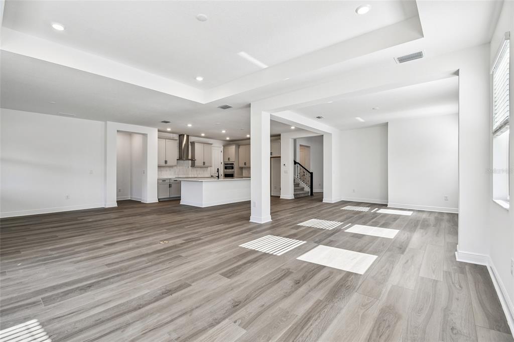 3677 142nd Terrace Parrish, FL 34219 - Photo 12 of 93 a view of a kitchen with wooden floor and a refrigerator
