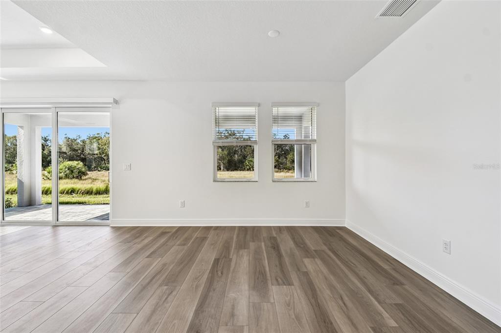 3677 142nd Terrace Parrish, FL 34219 - Photo 20 of 93 a view of empty room with wooden floor and fan