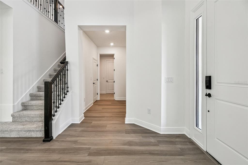 3677 142nd Terrace Parrish, FL 34219 - Photo 23 of 93 a view of a hallway with wooden floor and entryway
