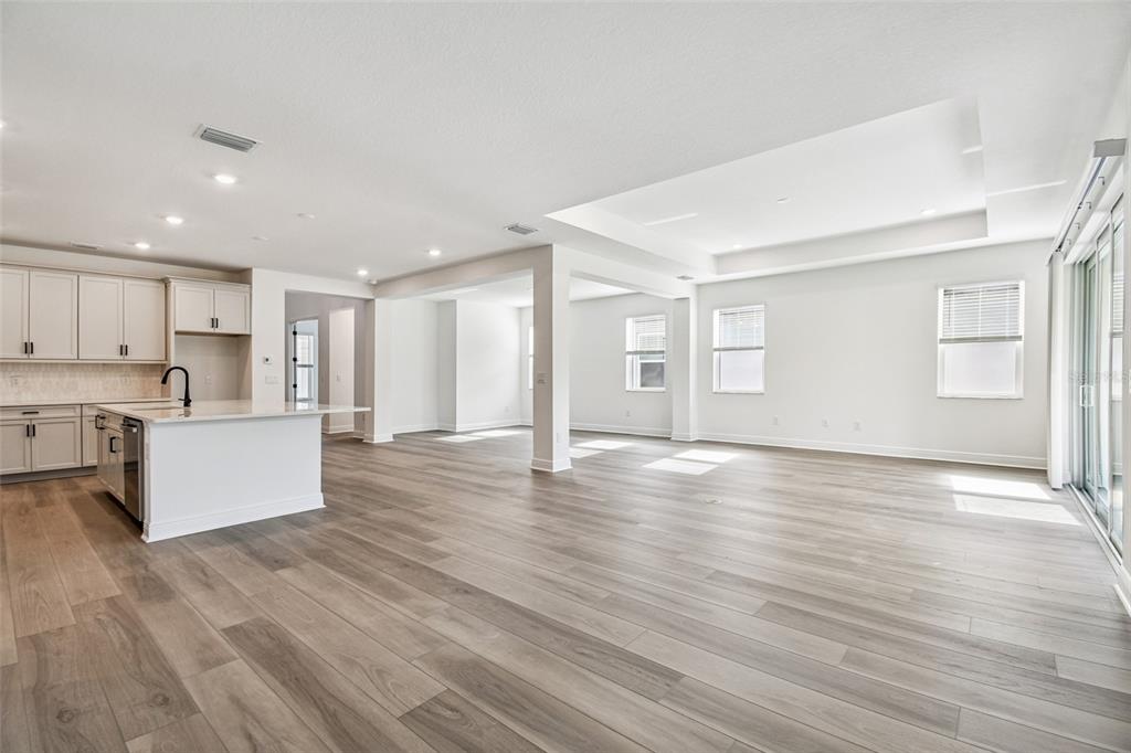 3677 142nd Terrace Parrish, FL 34219 - Photo 3 of 93 a view of kitchen with kitchen island wooden floors and stainless steel appliances