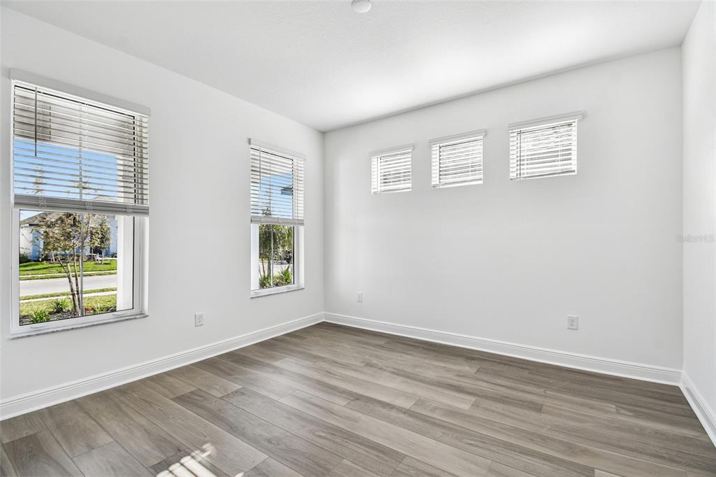 3677 142nd Terrace Parrish, FL 34219 - Photo 35 of 93 a view of an empty room with wooden floor and a window