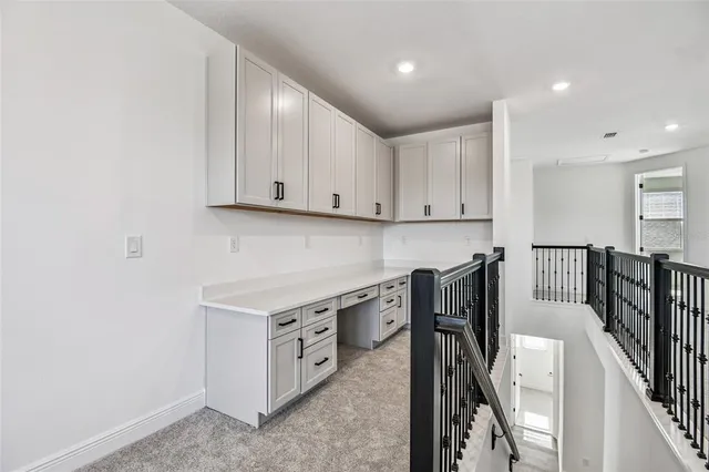 a kitchen with white cabinets and white appliances
