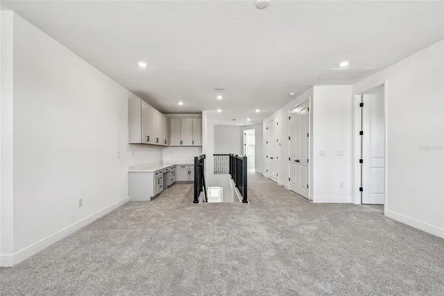 a view of a hallway with wooden floor and closet