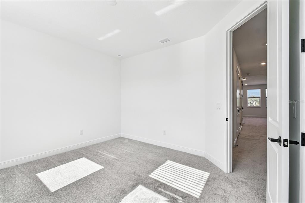 3677 142nd Terrace Parrish, FL 34219 - Photo 49 of 93 an empty room with wooden floor and windows