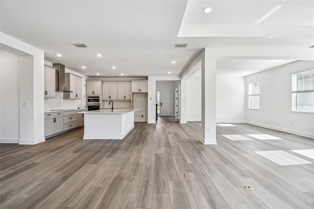 3677 142nd Terrace Parrish, FL 34219 - Photo 5 of 93 a view of kitchen with wooden floor and electronic appliances