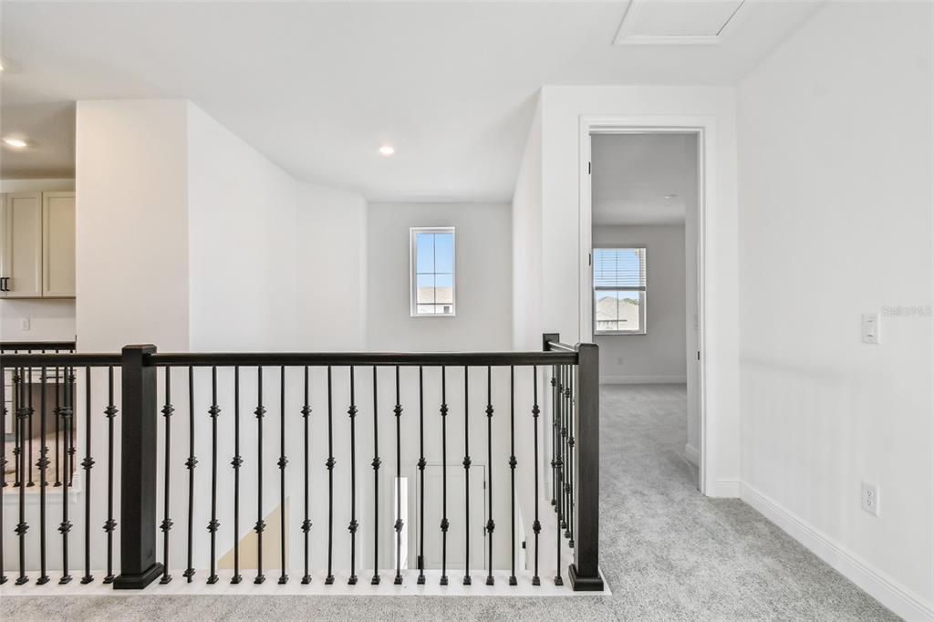 3677 142nd Terrace Parrish, FL 34219 - Photo 53 of 93 a view of a hallway with wooden floor and staircase
