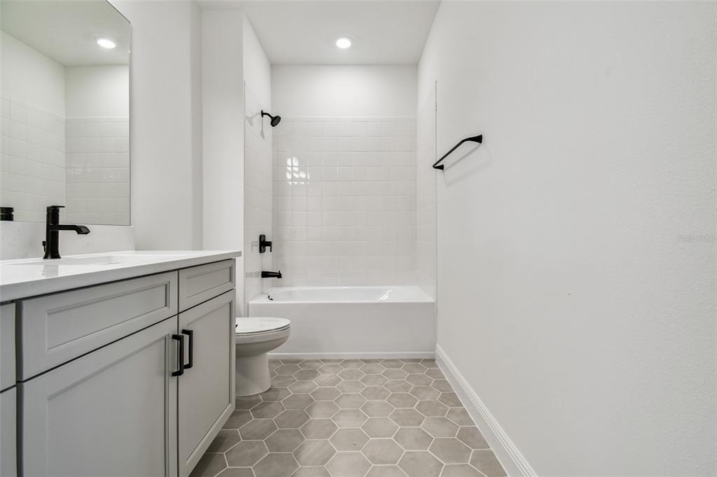 3677 142nd Terrace Parrish, FL 34219 - Photo 56 of 93 a bathroom with a double vanity sink toilet mirror and bathtub