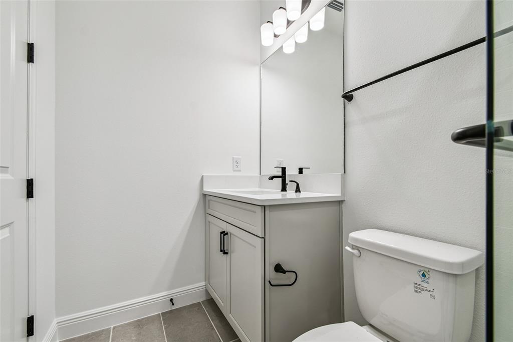 3677 142nd Terrace Parrish, FL 34219 - Photo 59 of 93 a bathroom with a sink a toilet a mirror and shower