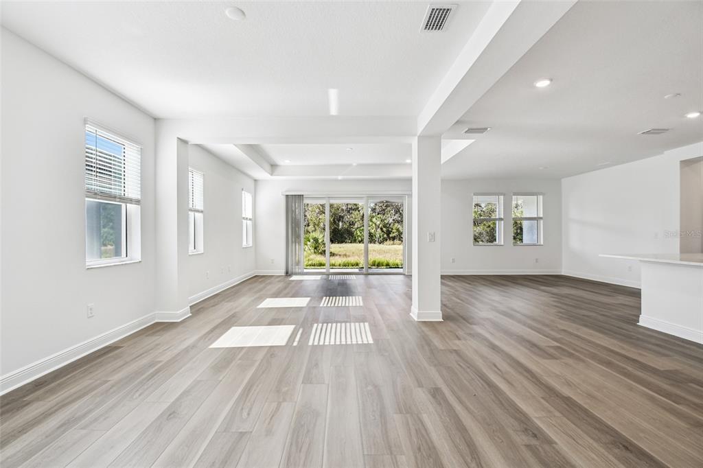 3677 142nd Terrace Parrish, FL 34219 - Photo 6 of 93 a view of an empty room with wooden floor and a window