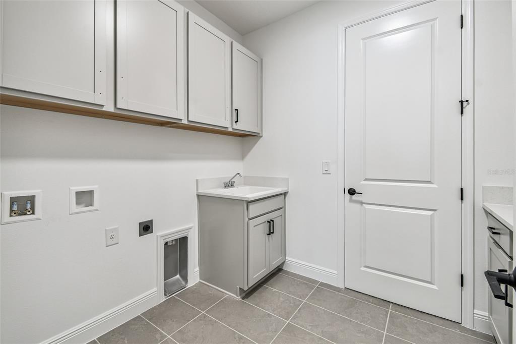 3677 142nd Terrace Parrish, FL 34219 - Photo 74 of 93 a kitchen with white cabinets and white appliances