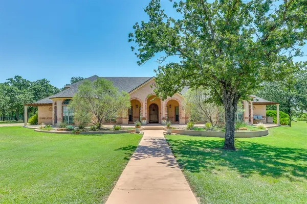 a front view of house with yard and green space