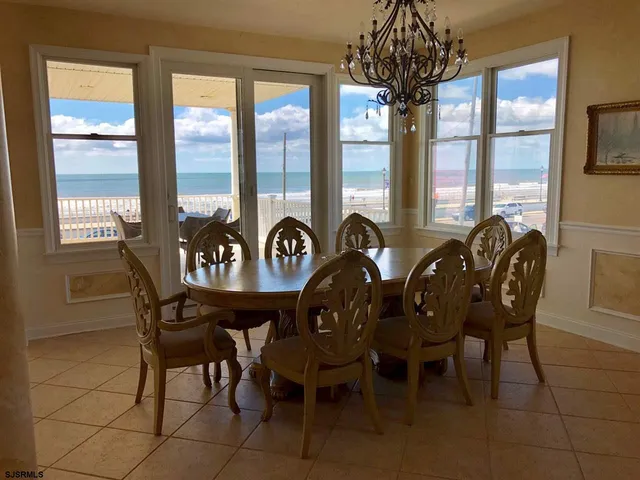 a large bedroom with a bed and a chandelier