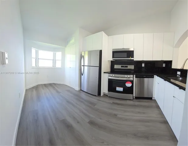 a kitchen with stainless steel appliances a refrigerator and a stove