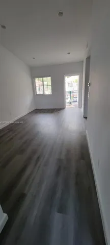 an empty room that has a window in it