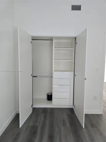 an empty room with wooden floor