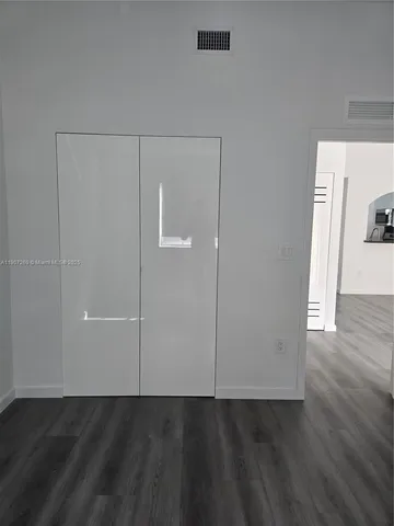 an empty room with wooden floor