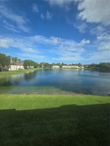 a view of a lake with houses in the back