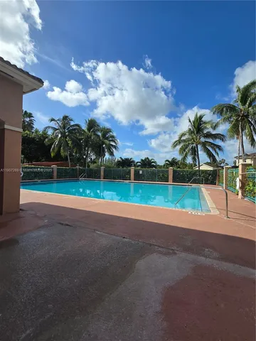 a view of a house with a big yard and potted plants