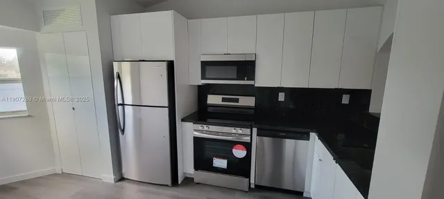 a kitchen with appliances and cabinets