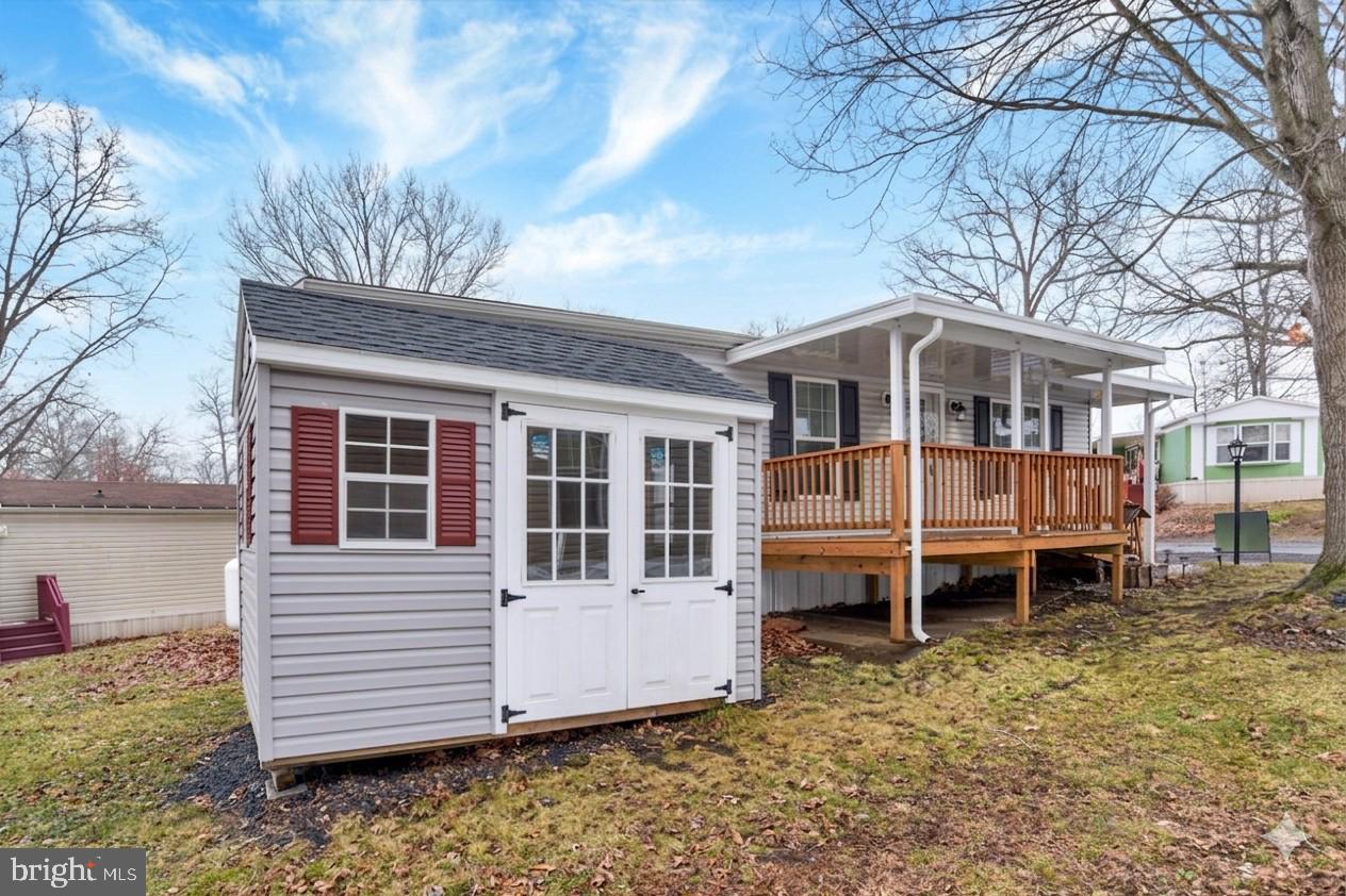a view of house with a yard and wooden fence