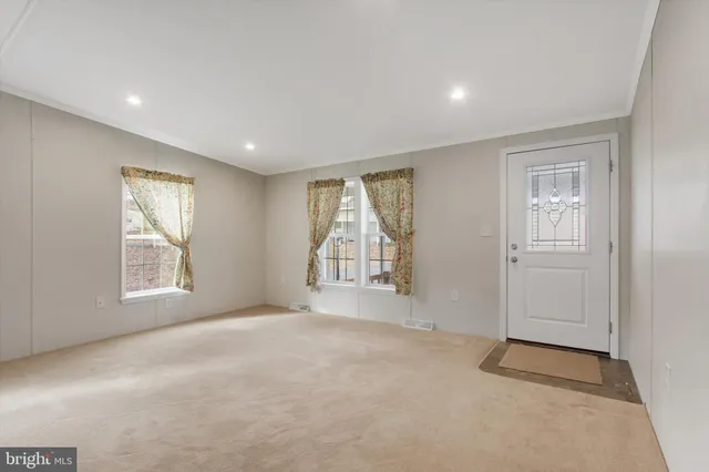 an empty room with windows and closet