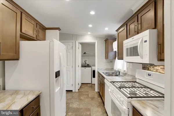 a kitchen with stainless steel appliances a stove a sink and a refrigerator