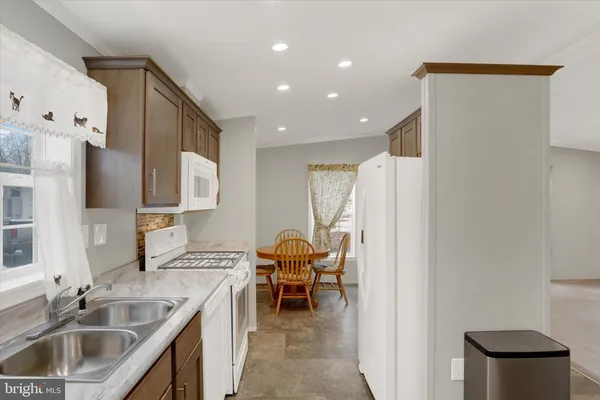 a kitchen with a sink and a refrigerator