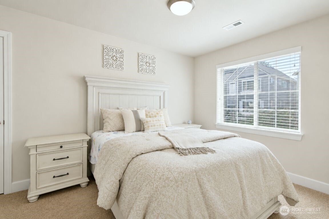 19607 25th Drive Southeast Bothell, WA 98012 - Photo 18 of 30 a large bed sitting in a bedroom next to a window
