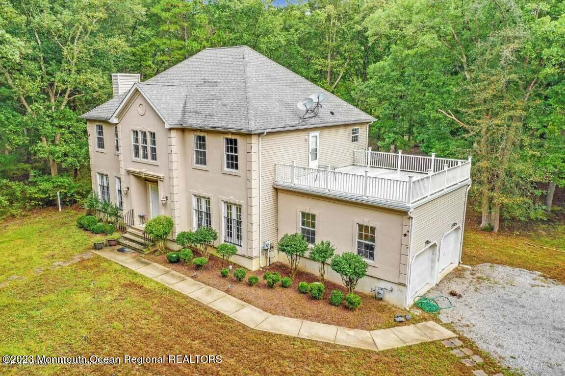 a aerial view of a house with a yard table and chairs