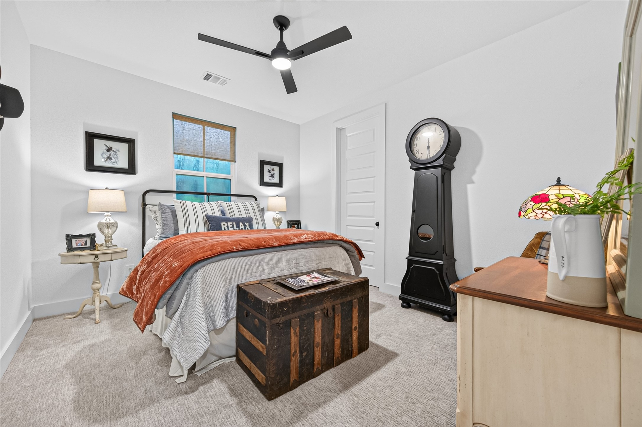 10915 Ruger Road Willis, TX 77378 - Photo 29 of 50 a bed room with a bed and a chandelier
