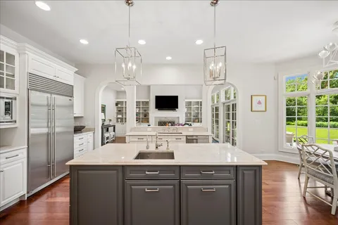a view of a dining room with furniture wooden floor and chandelier