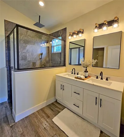 a spacious bathroom with a double vanity sink and a mirror